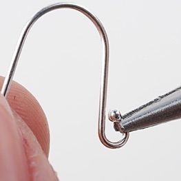 Opening earwire to attach earring